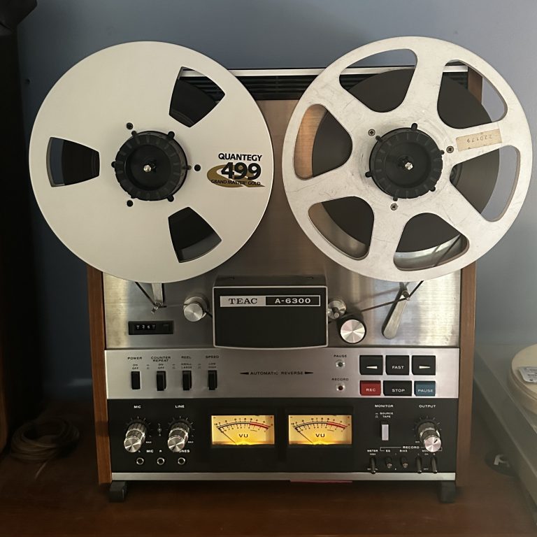 TEAC A-6300 reel-to-reel tape machine used for analog mastering, featuring Quantegy 499 Grand Master Gold tape, VU meters, and input controls. Ideal for high-quality audio mastering and vintage sound in professional music production.